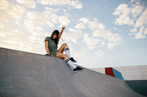 Happy urban woman in skate-park having fun