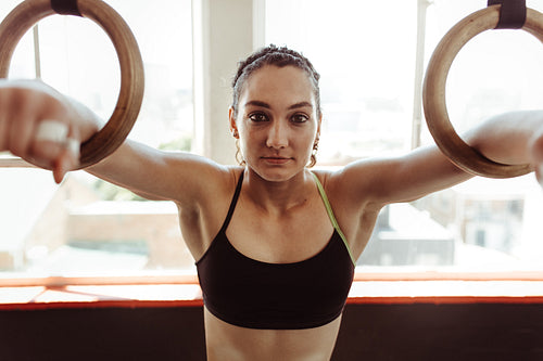Woman exercising with gymnastic rings 