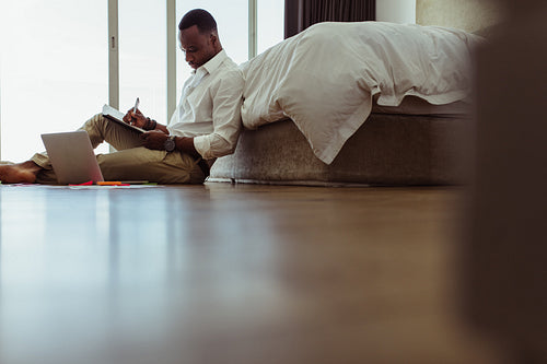 Man working on laptop sitting at home