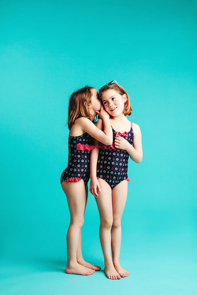 Cute girl sharing secret with her friend