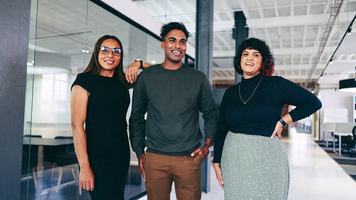 Happy team of businesspeople smiling while standing together