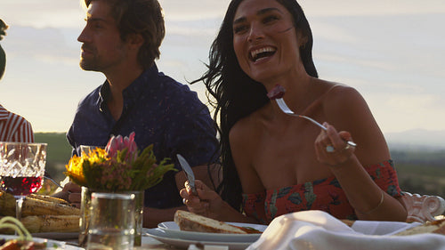 Woman having food with friends at a party