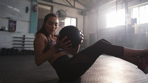 Woman doing workout using medicine ball