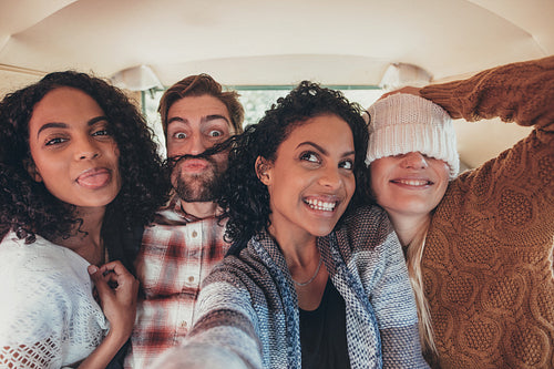 Friends taking selfie on road trip