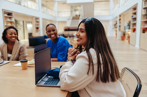 Confident businesswomen in a modern office setting during a marketing meeting