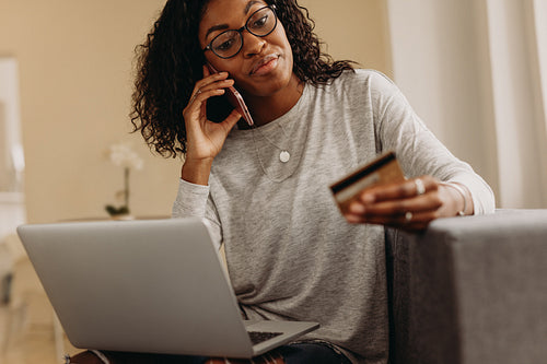Woman making online transaction using credit card
