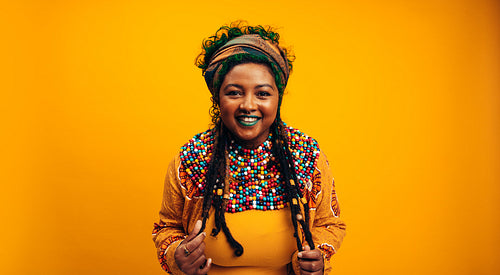 Happy young woman wearing African clothing