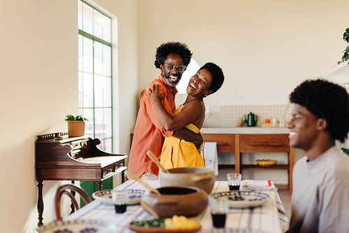 Mature couple dancing and dining together at a traditional table