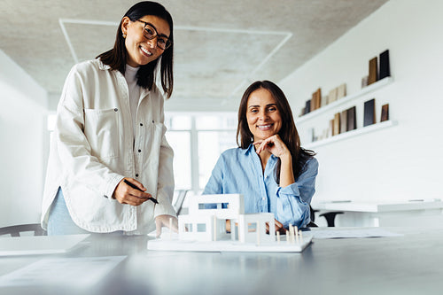 Creative business women working on a house design project in an office