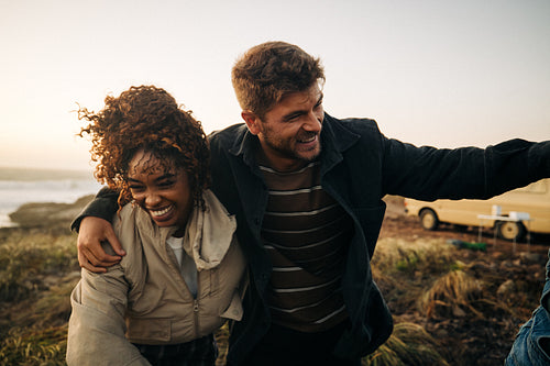 Couple outdoors walking together at the coast
