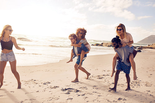 Group of friends having fun on the beach