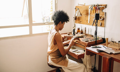 Female worker designing jewelry