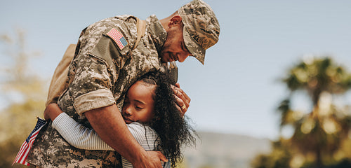 Affectionate military reunion between father and daughter