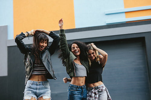 Young women having fun on city street