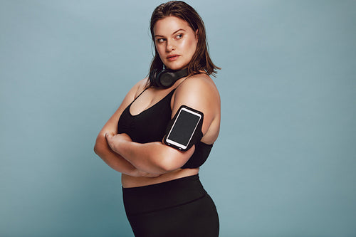 Confident overweight female in sports gear
