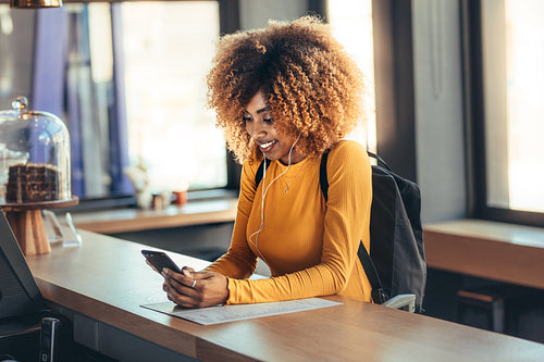 Female traveller standing at the billing counter of a coffee shop