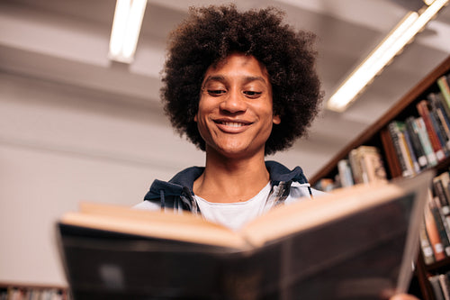 Young african student studying in library