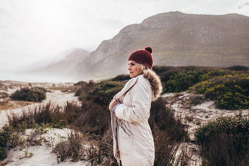 Female on winter vacation looking at beach