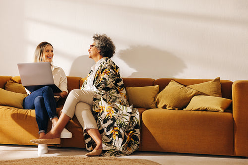 Two happy businesswomen working in an office lobby