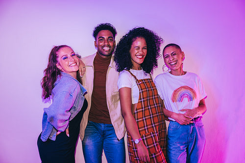 Happy friends smiling at the camera at a party
