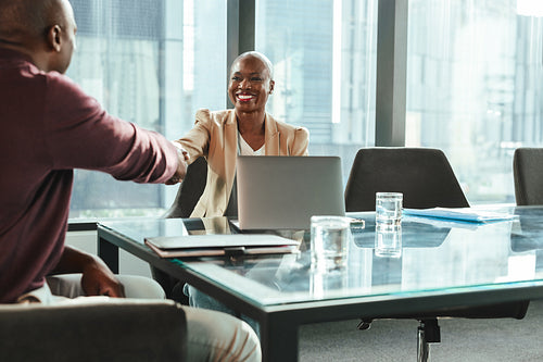 Partners shaking hands to an agreement after a successful business meeting in the office