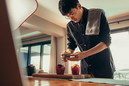 Photographer styling dessert for photography in studio