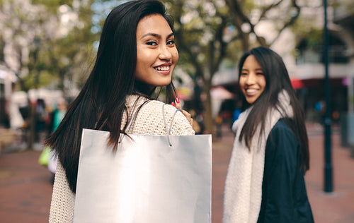 Rear view of a woman carrying a shopping bag