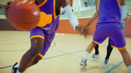 Young men playing basketball on court