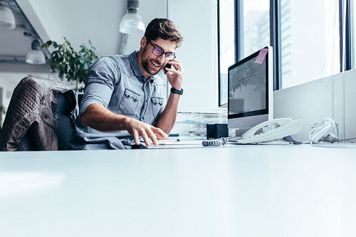 Young businessman making call on smartphone