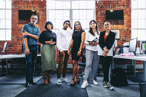 Diverse team of businesspeople standing together in an office