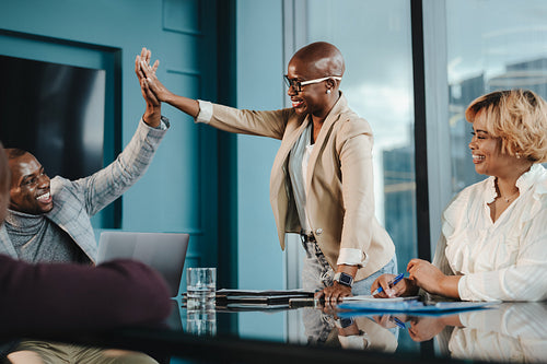 Successful business colleagues celebrating together in the office