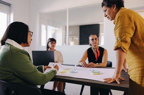 Group of professionals brainstorming in a meeting in a modern office setting
