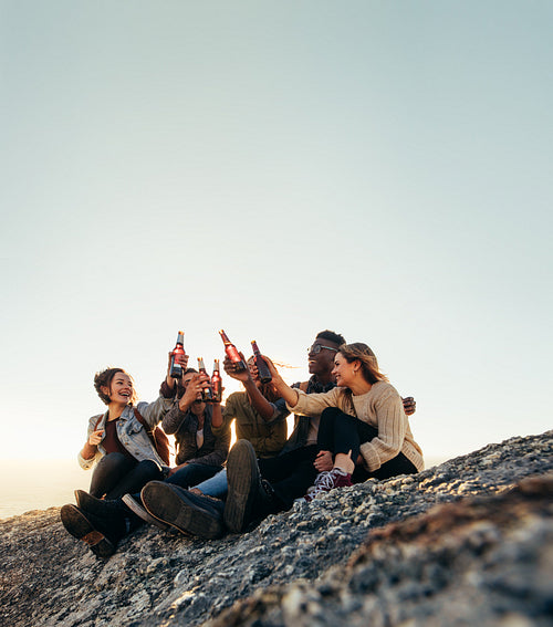 Friends on a mountain top partying with beers