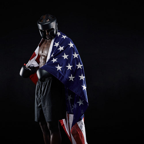 African boxer with the flag draped around his body