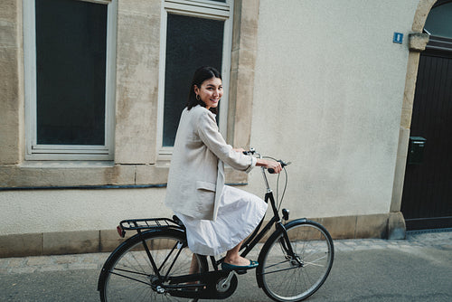 Asian woman travelling with a bicycle in the city