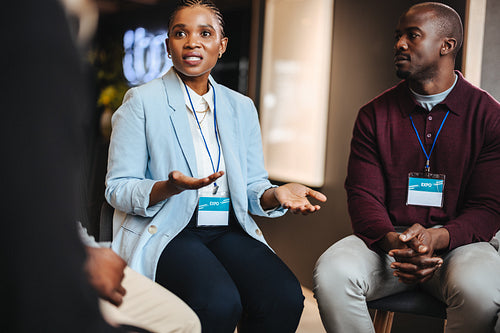 Professional colleagues engaging in a discussion at a business expo event