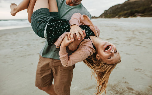 Father and daughter having lots of fun at the beach