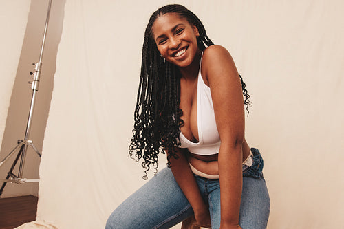 Smiling woman looking at the camera in a studio