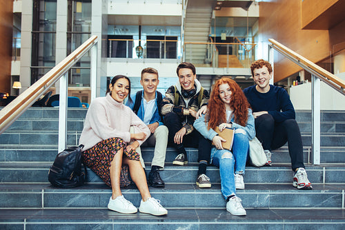 College students sitting on steps after class