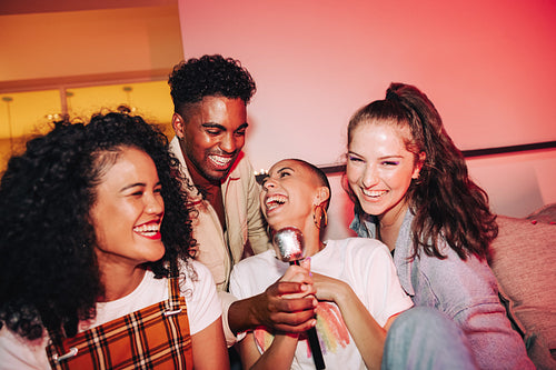 Blissful friends enjoying karaoke night together
