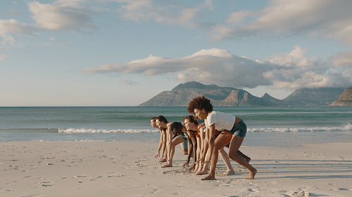 Friends running a race on the beach