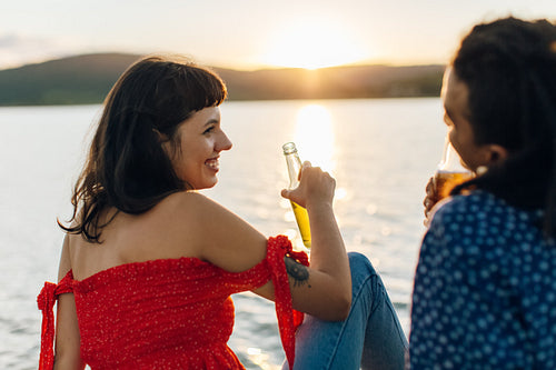 Smiling young couple relaxing with beers on a vacation