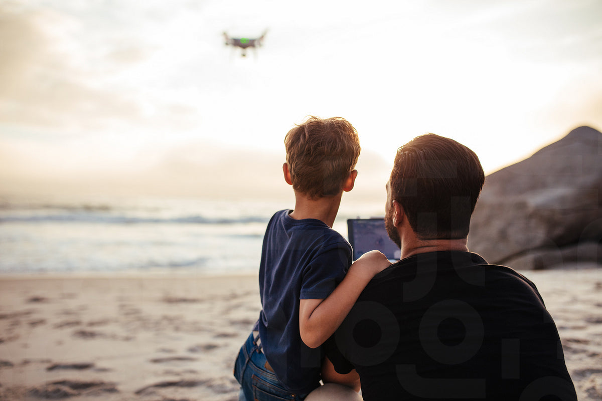 Father and son flying drone at the beach – Jacob Lund Photography Store ...