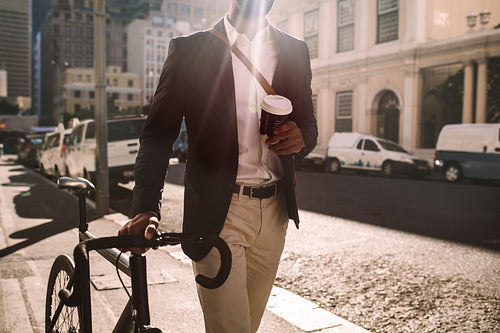 Young businessman going to work by bike