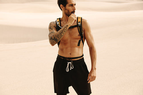 Athlete drinking water from hydration pack