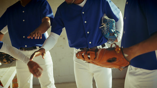 Baseball team huddles in dugout, ready for intense play
