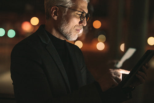 Mature man working late night in office