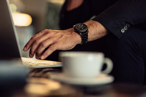 Close up of businessman using laptop on table