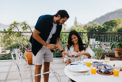 Couple enjoying a Brazilian churrasco on a beautiful outdoor patio