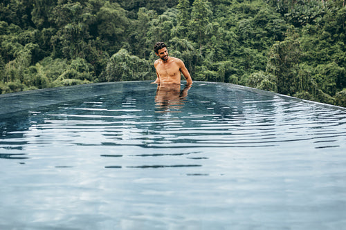 Smiling man relaxing in a pool